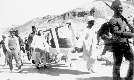 Carter, left, escorts a sarcophagus from the site. 1922.